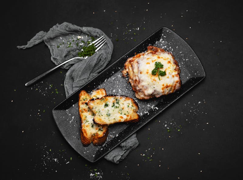 garlic bread with melted cheese and fresh herbs from pizza factory